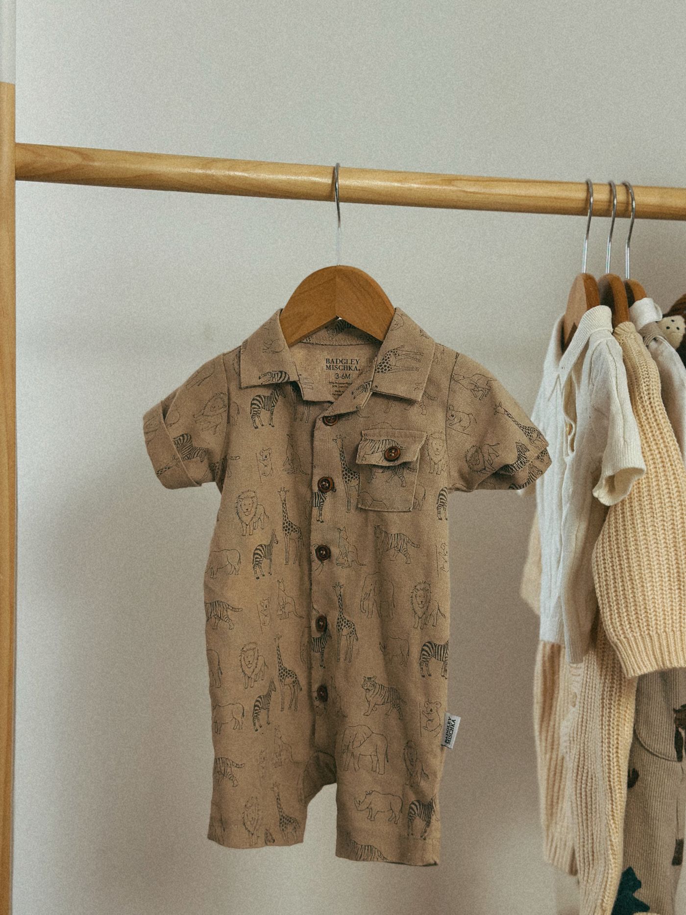 Knitted children's clothes on wooden hangers